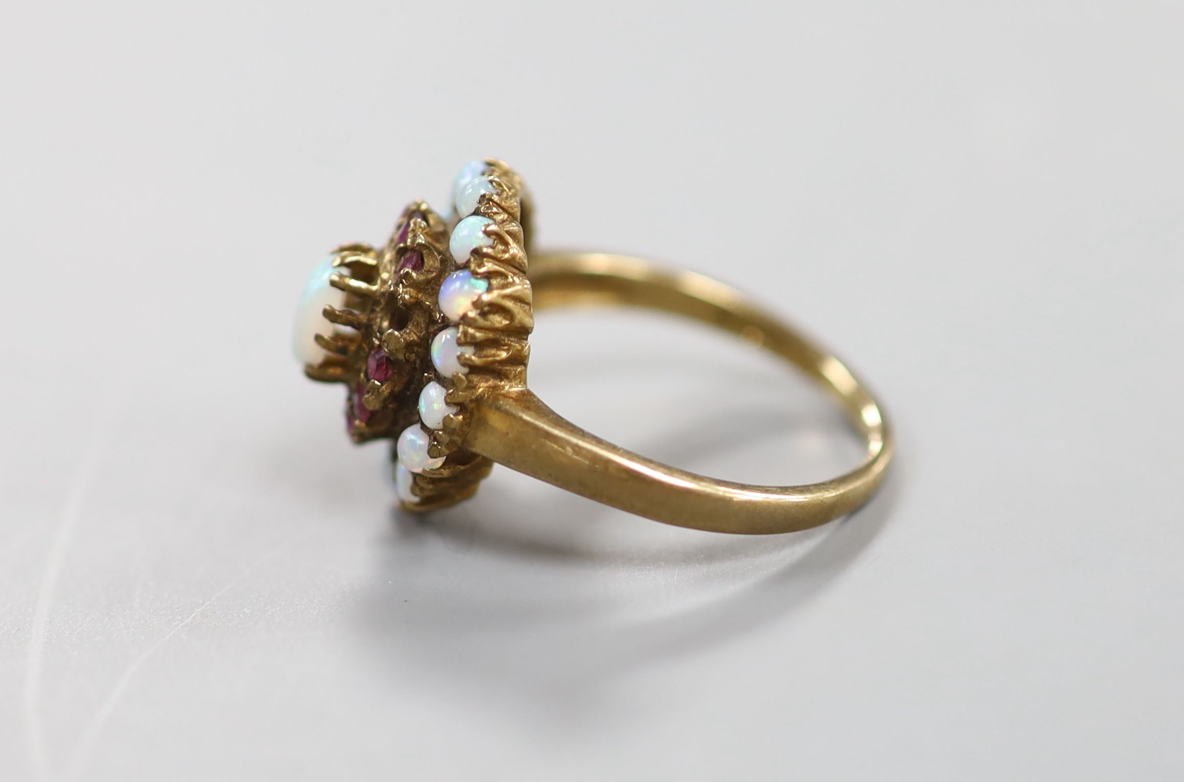 A 1960's 9ct gold, ruby and white opal set cluster ring (ruby missing)